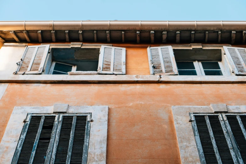 an orange building with some windows on top