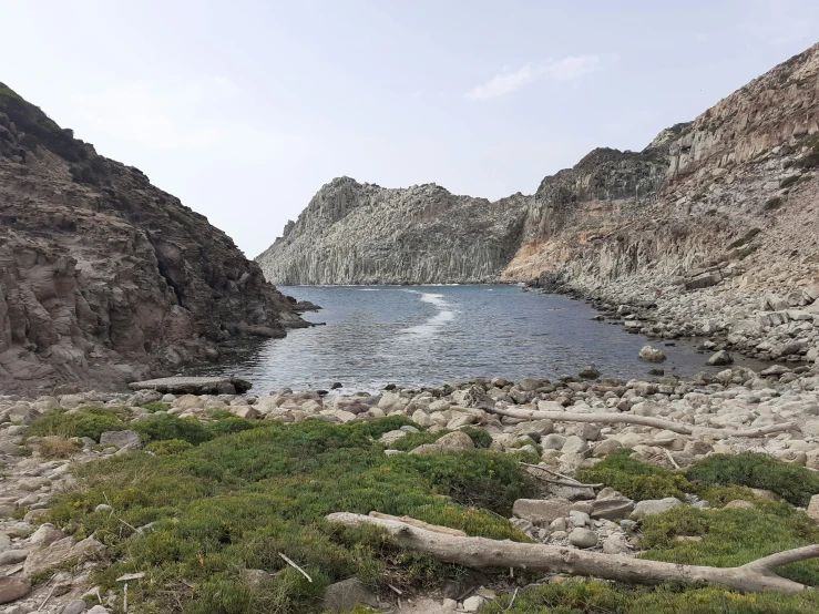 a lake surrounded by a rocky cliff face