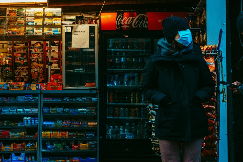 the woman stands at the door of the convenience store