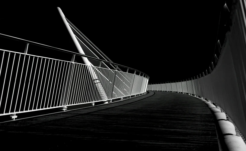 a walkway that is in the dark with a black and white po