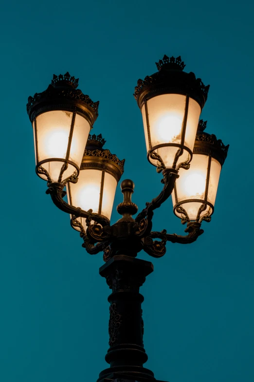 a close up of two light poles in the dark