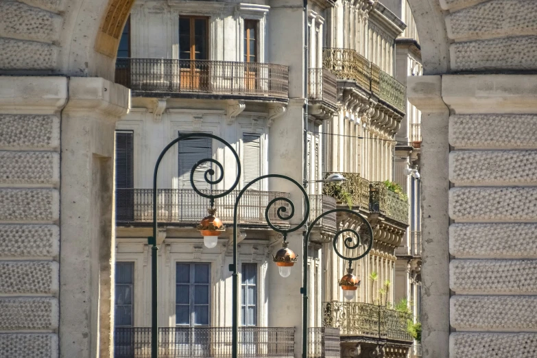 looking through an arched window onto a building with balconies