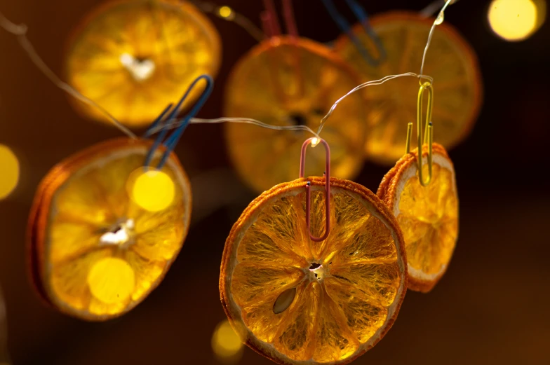 some kind of orange shaped decoration with strings hanging