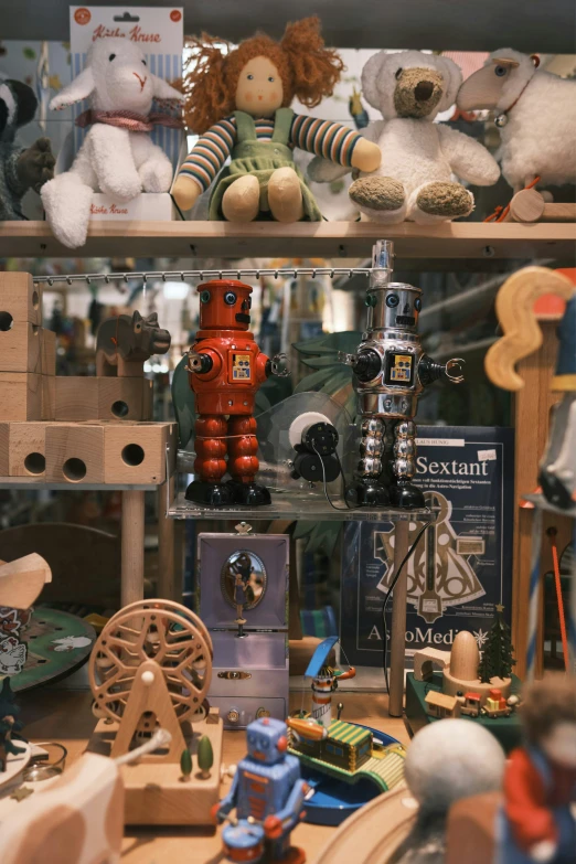 an assortment of dolls and other toys in a display case