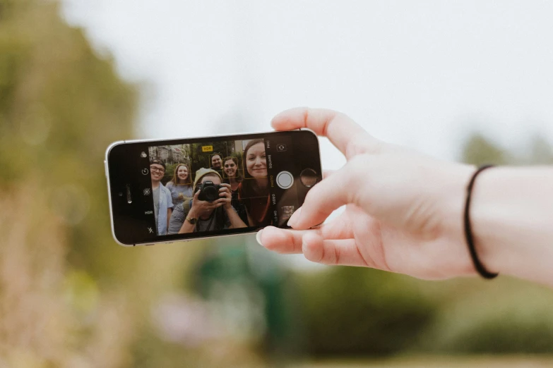 someone taking pictures of people on their cell phone