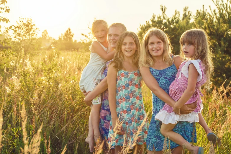 four s standing in the tall grass together