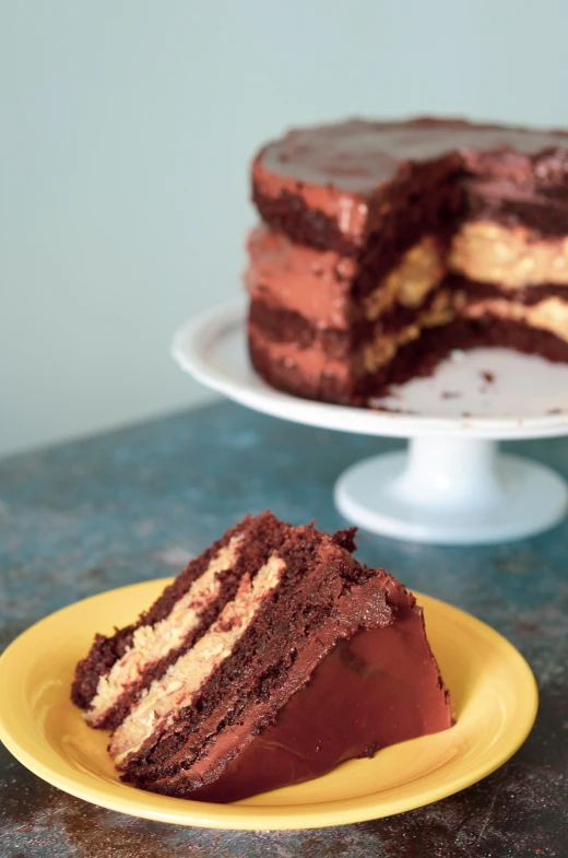 chocolate and white cake with one slice cut out on yellow plate