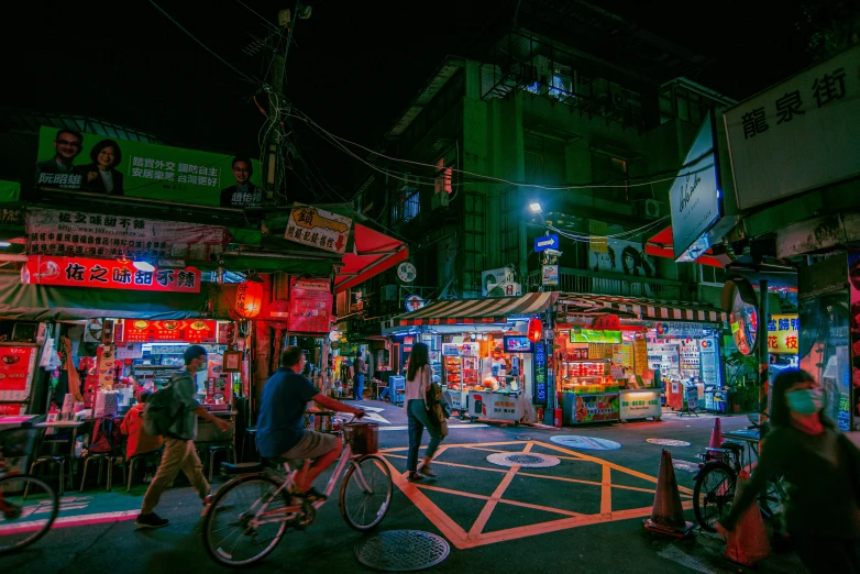 an urban street corner has many shops lit up