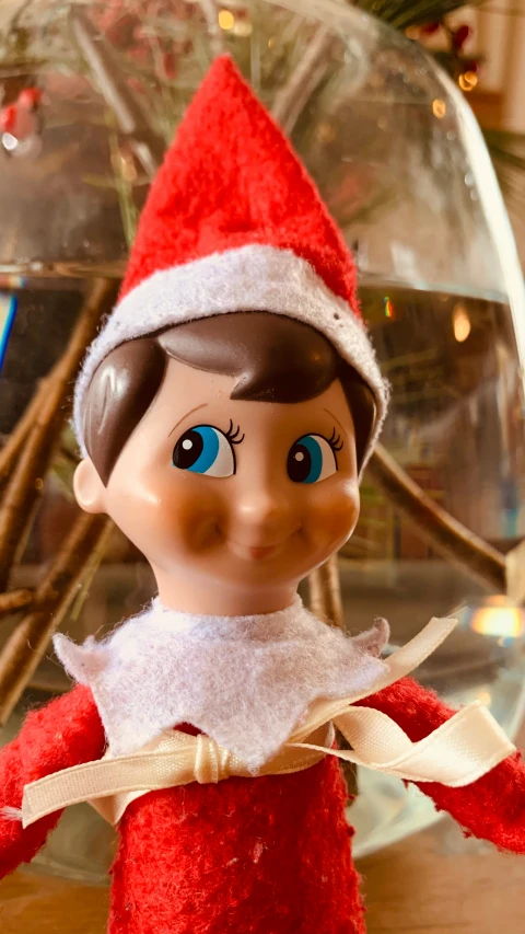 a red elf doll with brown hair and blue eyes