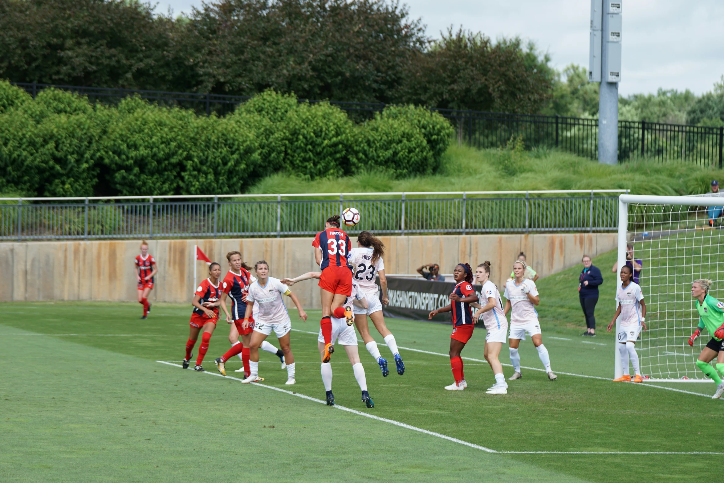 a group of women playing soccer against each other on a field