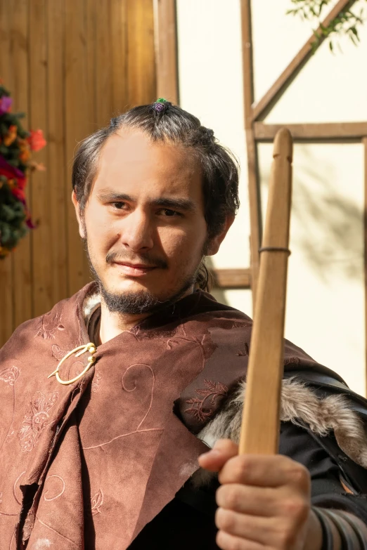 an image of a man holding a wooden staff