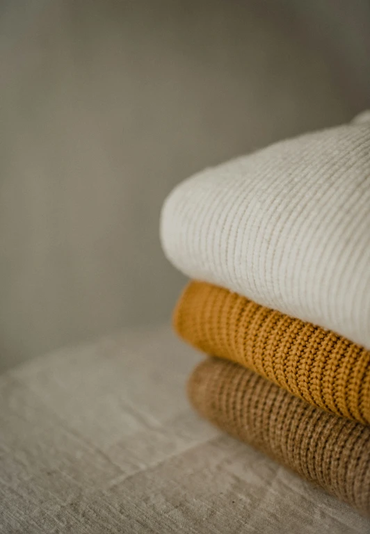 stacked towels in different colors, textured on top of each other