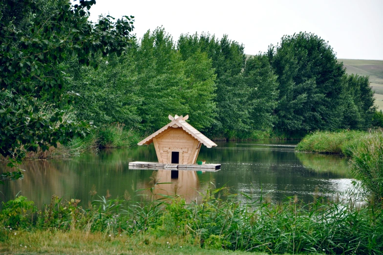 a boathouse sitting on a wooden dock in a lake