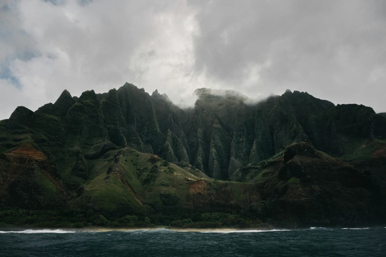 a cloudy day above an island and mountains