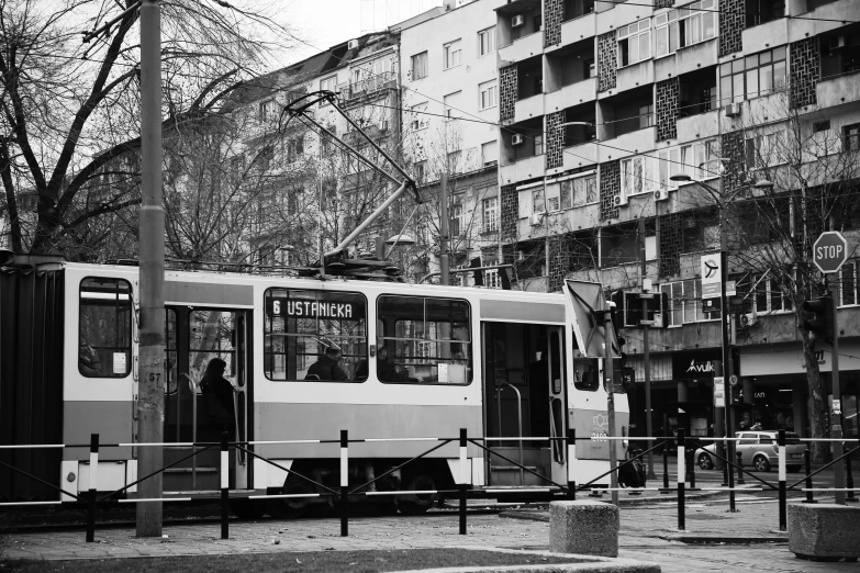 a black and white po of a bus parked in front of buildings