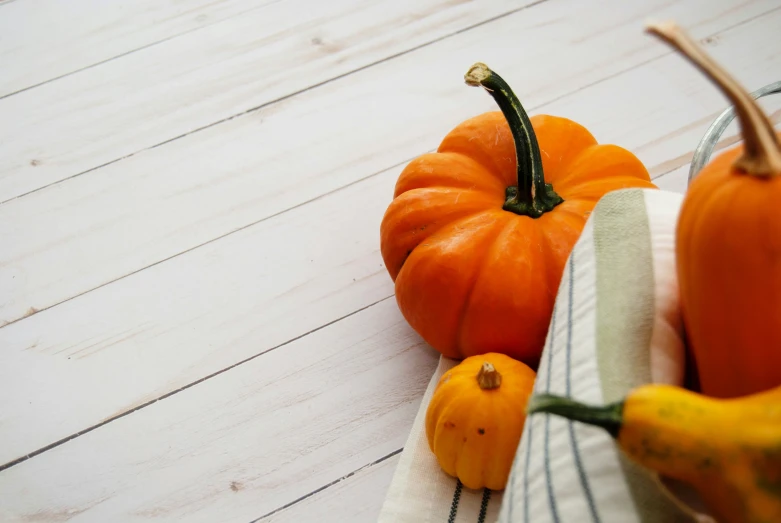 a small group of fresh fruit sits on a white wooden table