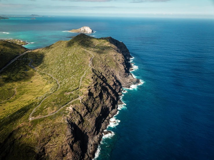 an island surrounded by the ocean with very tall cliffs