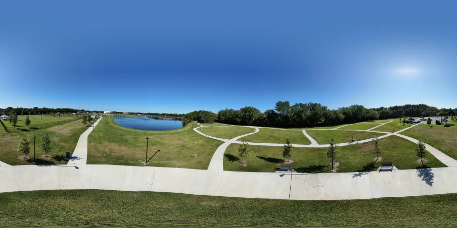 a green grassy field next to a blue sky