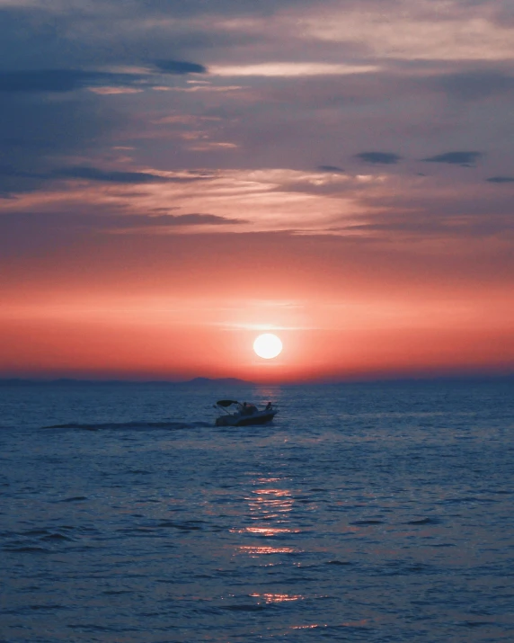 a boat is seen sailing out on the water