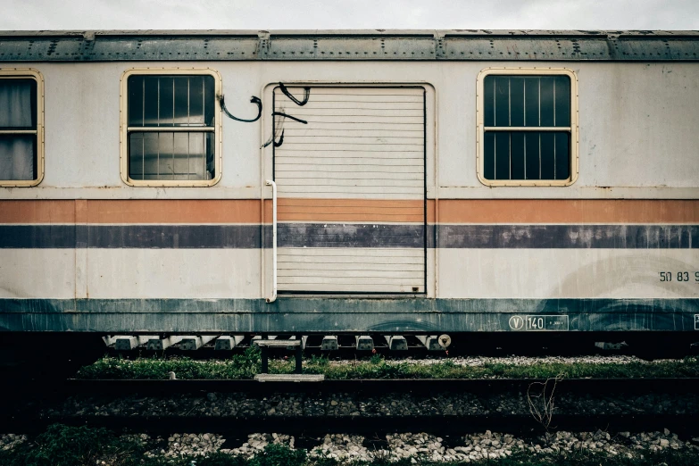 a rusted train car with a painted garage door