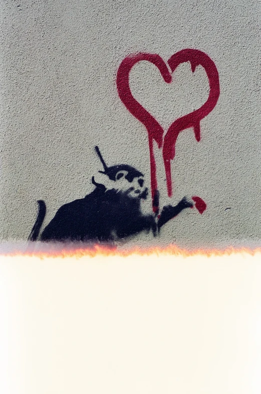 the word love has been sprayed onto the wall with a red heart