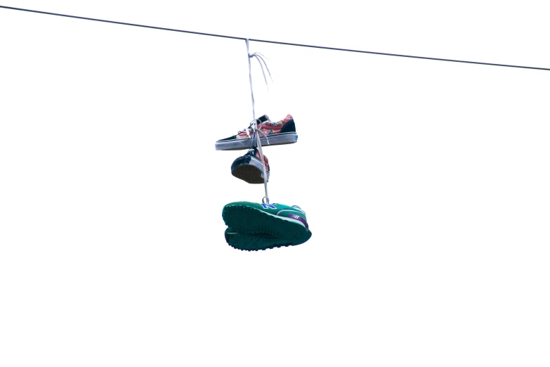 a pair of shoes are hanging on wires