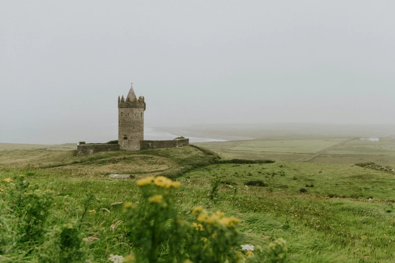 an old castle sits on top of a hill