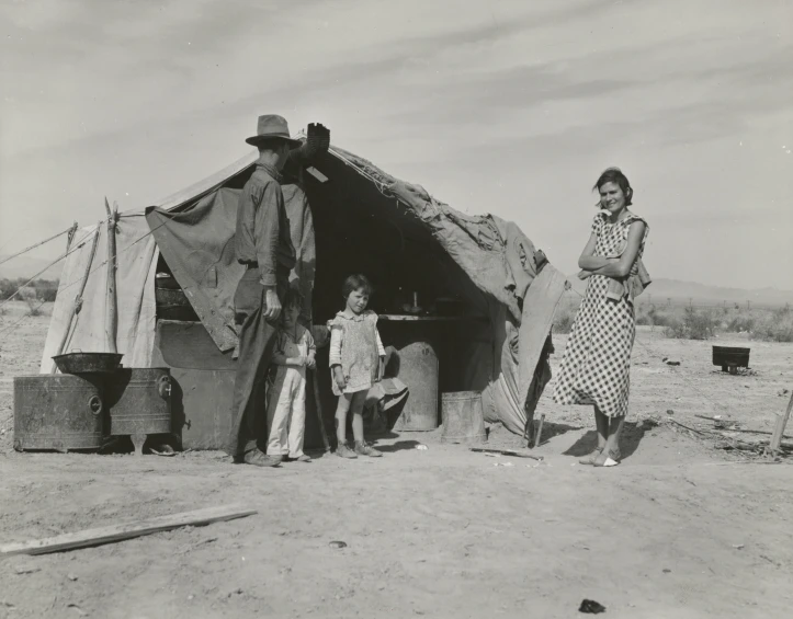 a couple of women standing next to a tent