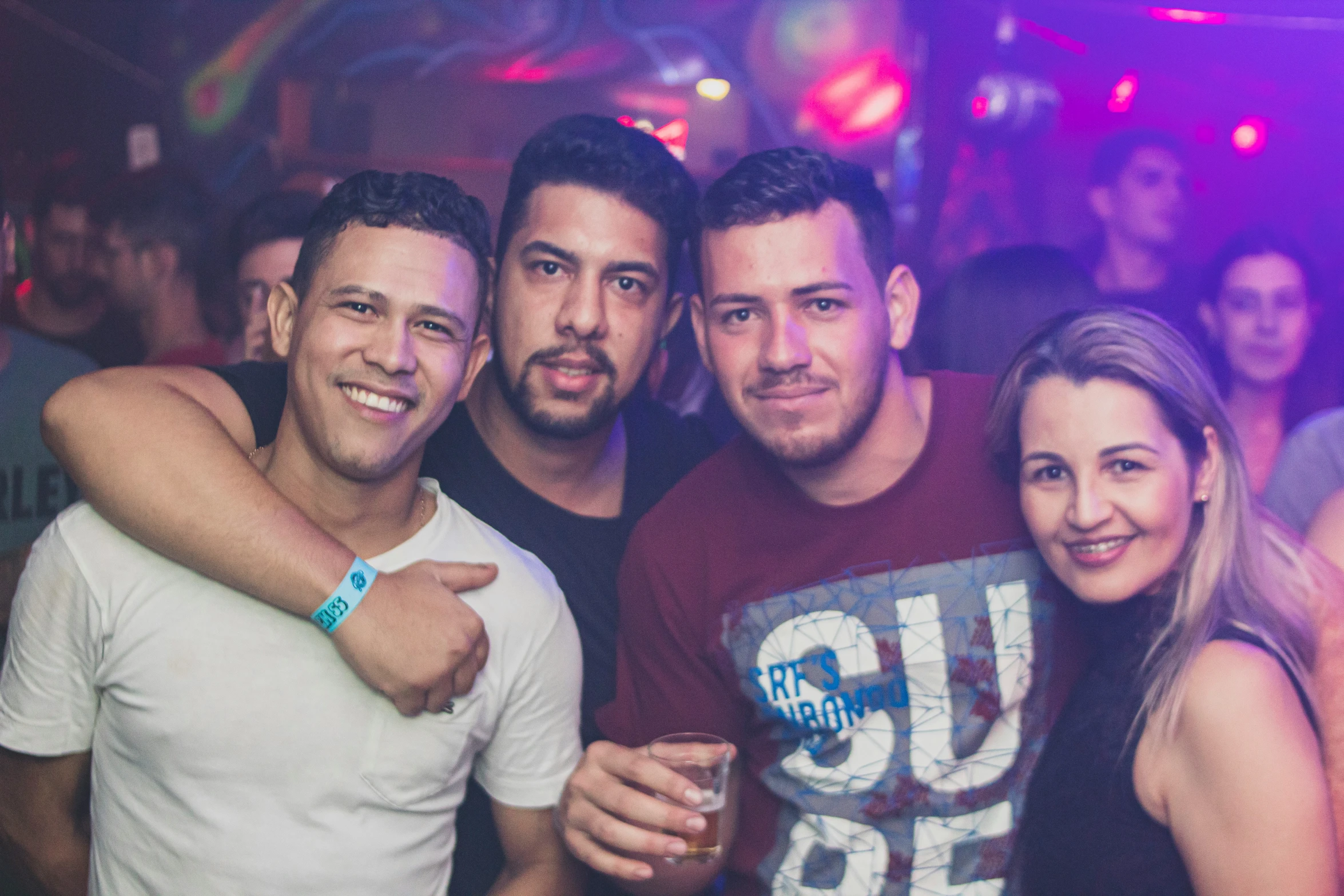 four people posing for the camera while holding their thumbs up