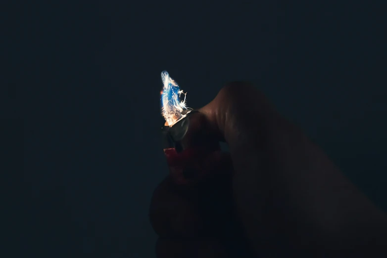 a piece of glass in the dark with tiny blue lights