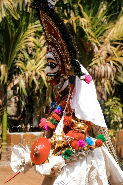 a person wearing a mask holding items