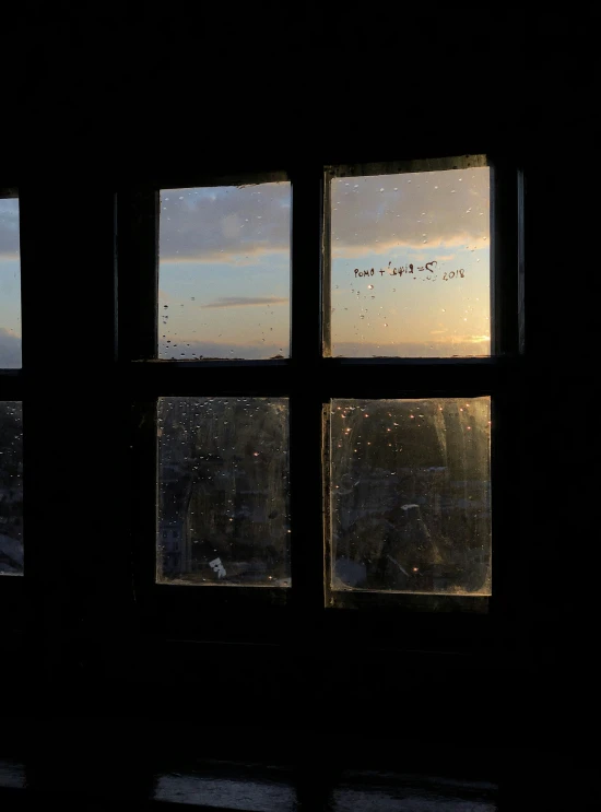 a window with an image of rain outside and a sky outside