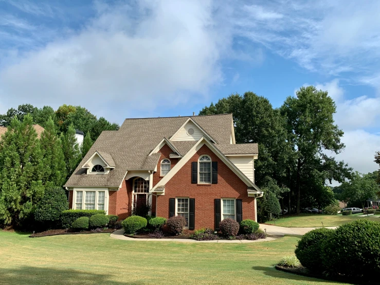 a red house with two levels and brown trim