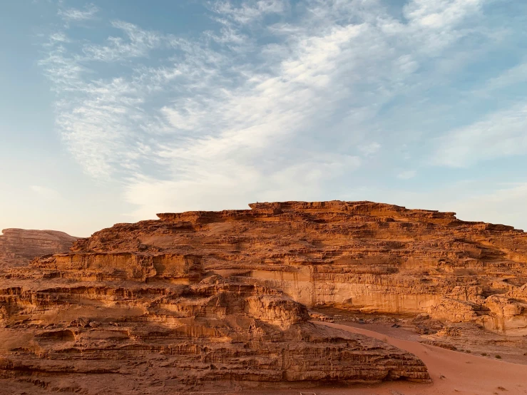 large rock formations near the desert under a cloudy sky