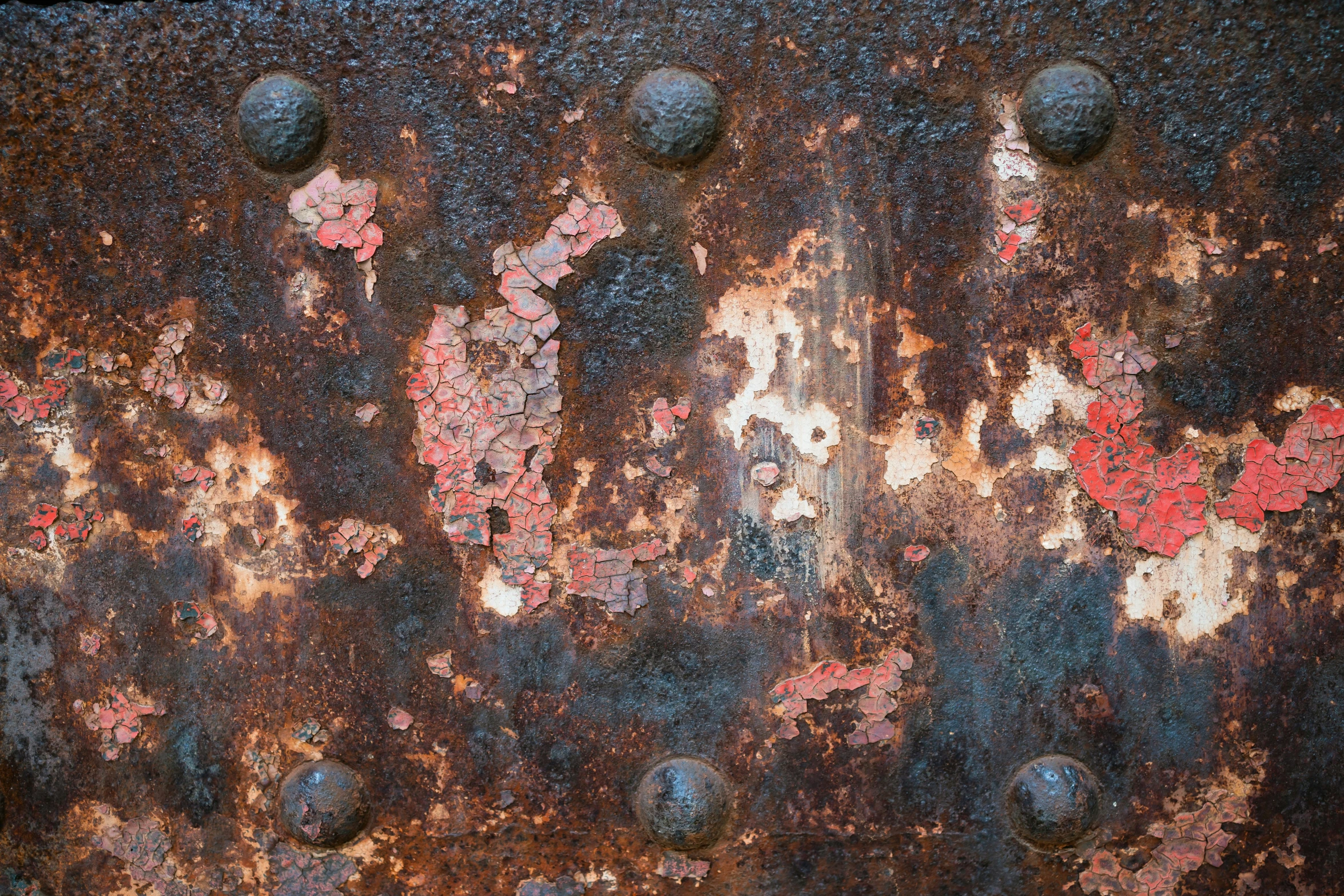 old rusty metal surface with holes in the wall