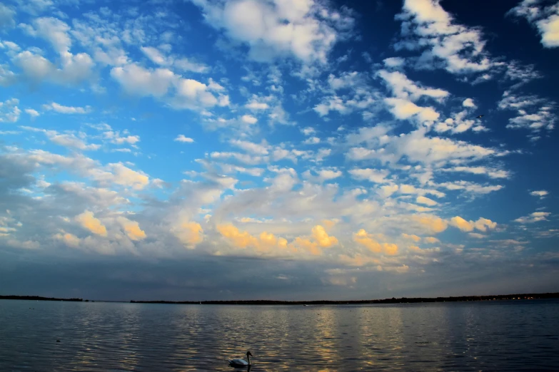 an image of clouds that are over water