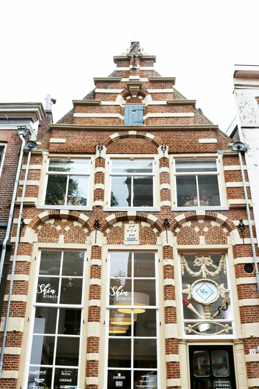 the store front of the old brick building with a clock on it