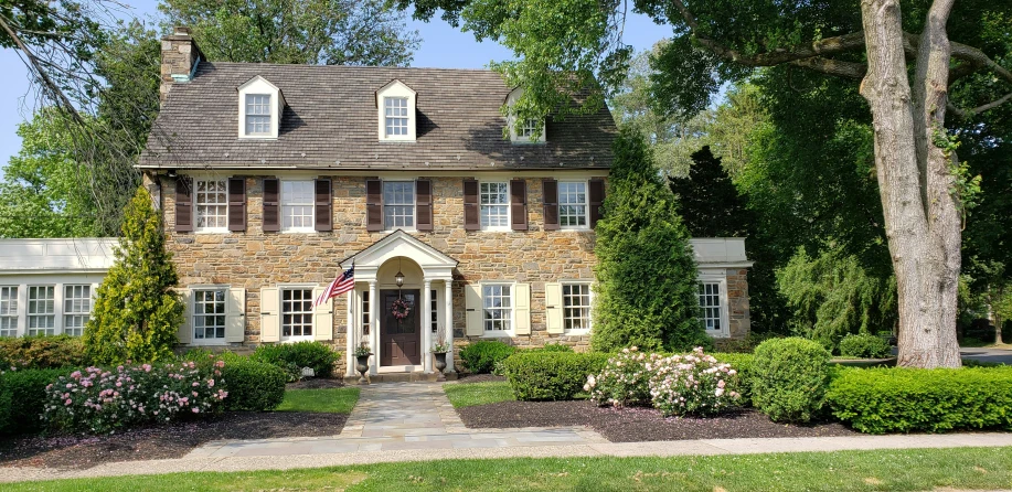 a stone house with trees in the foreground