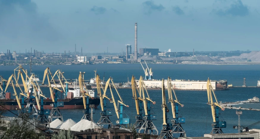 a large body of water surrounded by small cranes