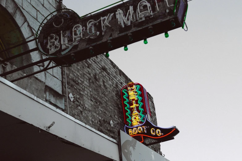 a brick building that has a neon sign on it