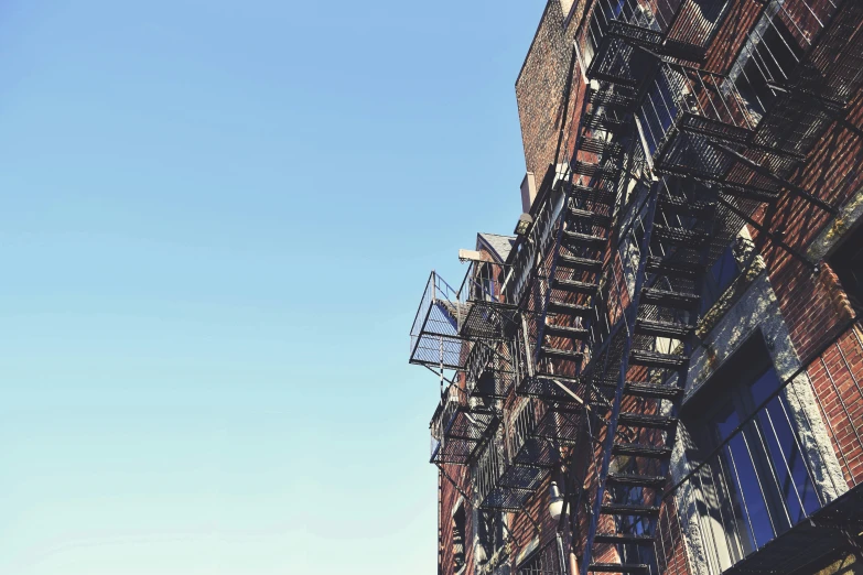 a view of a fire escape ladder and blue sky