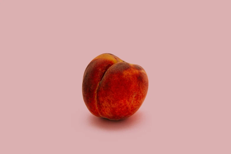 two peaches are in a pink colored background