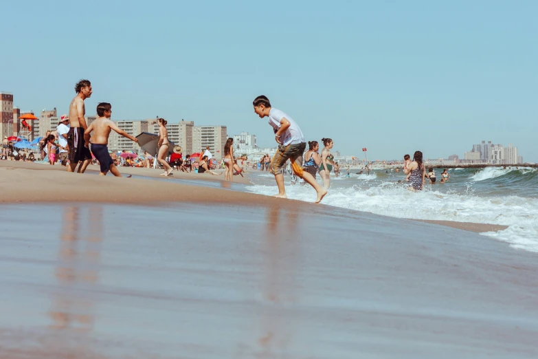 boys playing in the ocean at a beach