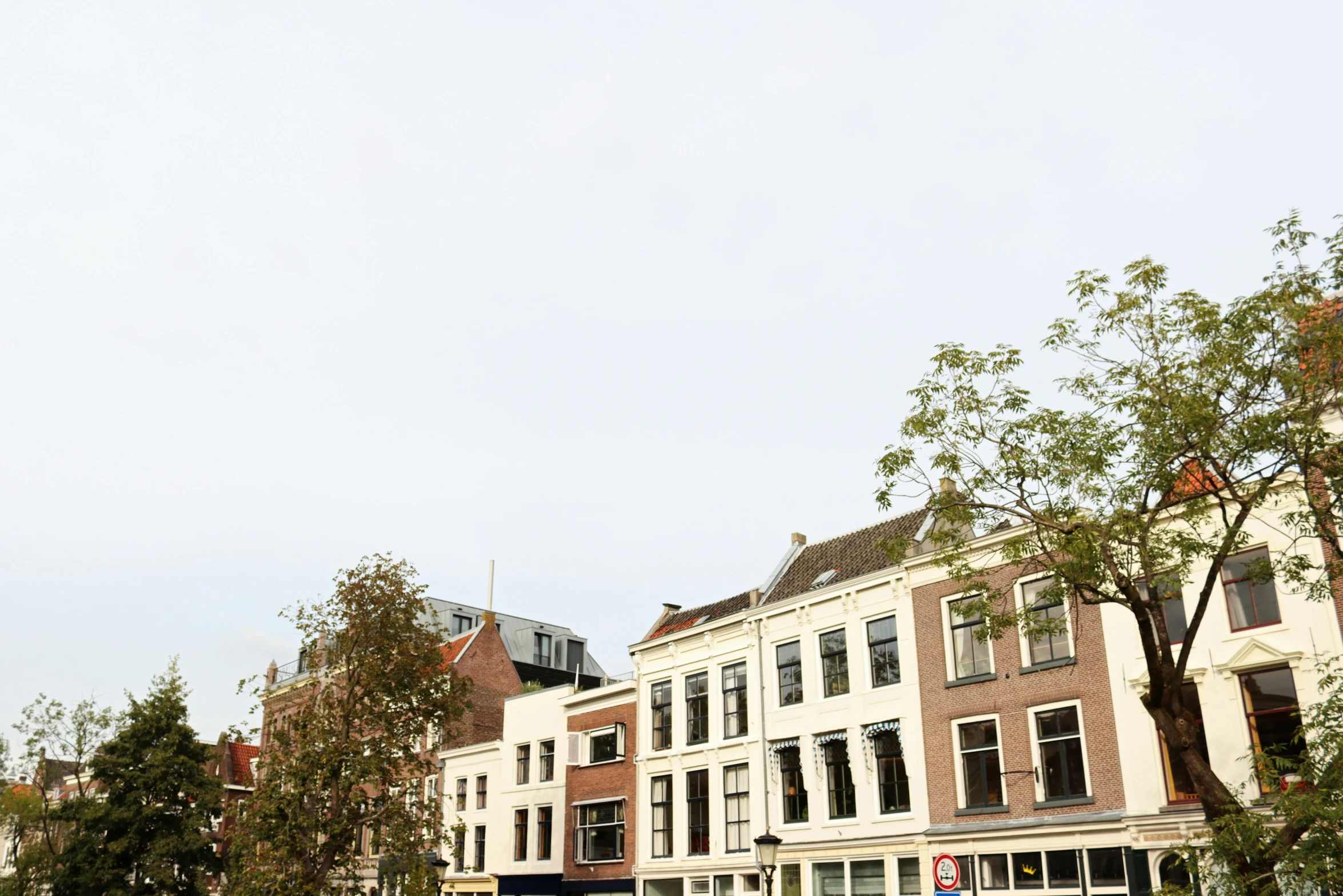 a number of buildings with windows in the middle of a street