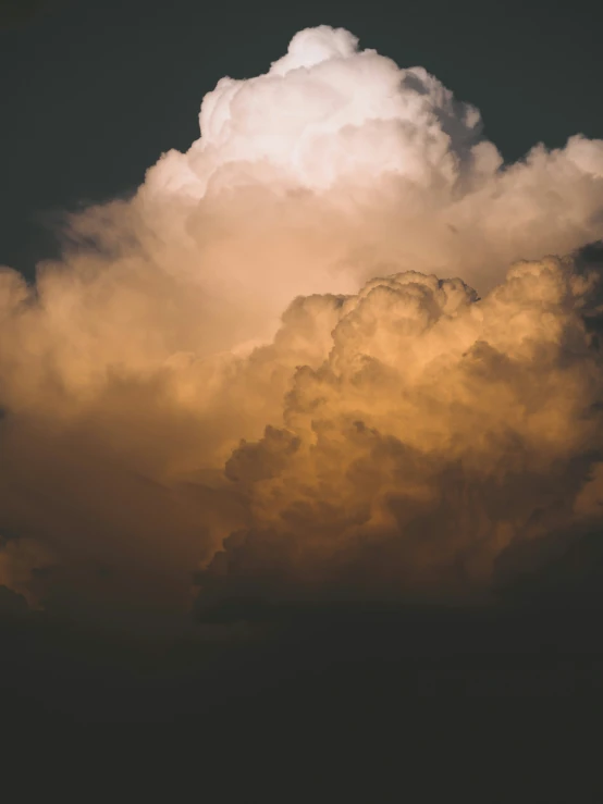 a plane is flying by in the sky with clouds