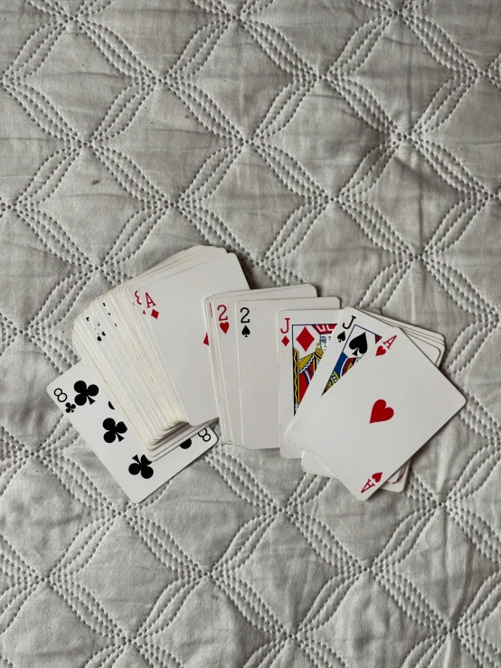 four cards are sitting on top of a quilt