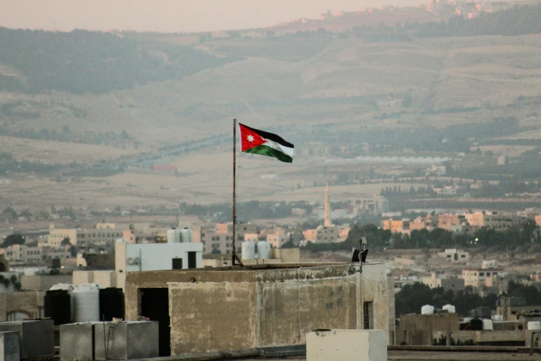 two flags that are sitting on a roof