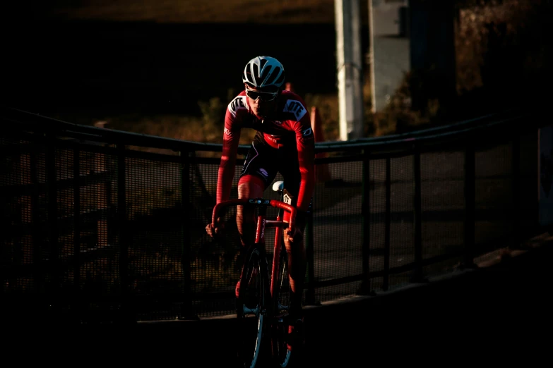 a cyclist is riding his bike across a bridge