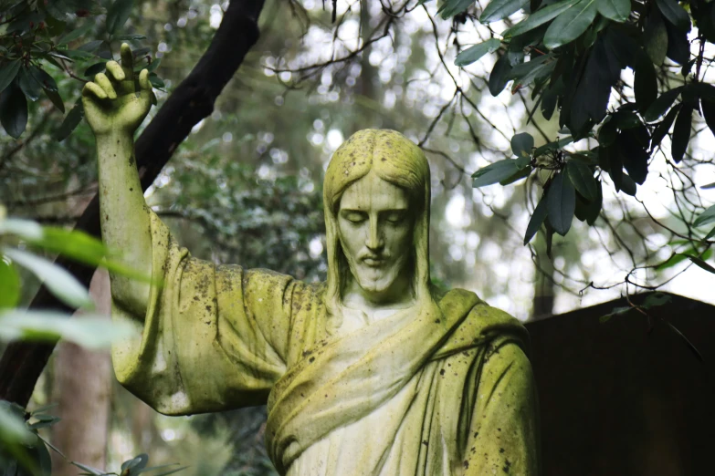 statue of jesus holding up an apple with both hands