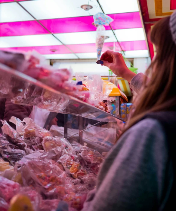 two women are shopping in a candy stand